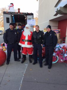Santa with Westland Police Officers posing for a picture during the Stuff A Swat Event at Target