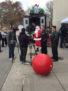 Santa with Westland Police Officers doing interview for the news for the Stuff A Swat Truck Event